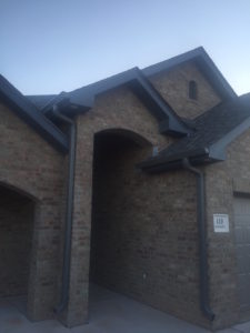 Charcoal Gray Continuous Gutters entry of house