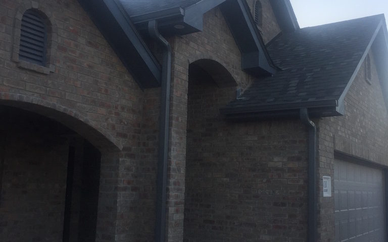 Charcoal Gray Continuous Gutters front of house